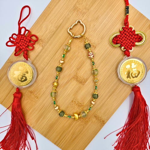 Green lunar new year phone charm made with glass and metal beads - product is shown with Lucky Knotted Talismans.